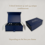 Blue jewelry box with 'Henry Francis' branding on a light gray background