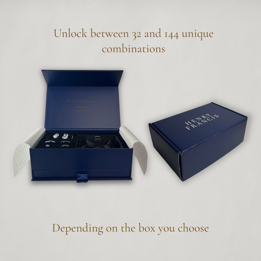 Blue jewelry box with 'Henry Francis' branding on a light gray background