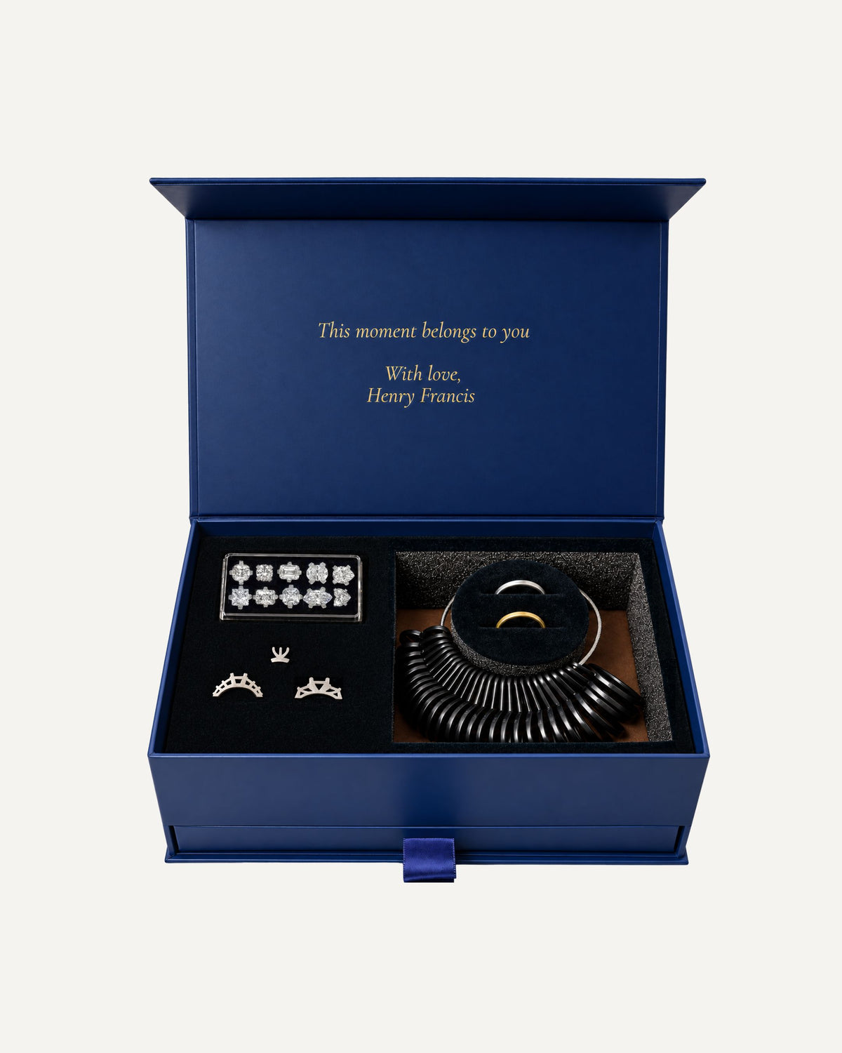 The At-Home Ring Try-On Kit open, showing ten stone shapes, three setting styles, a ring sizer and two try-on bands
