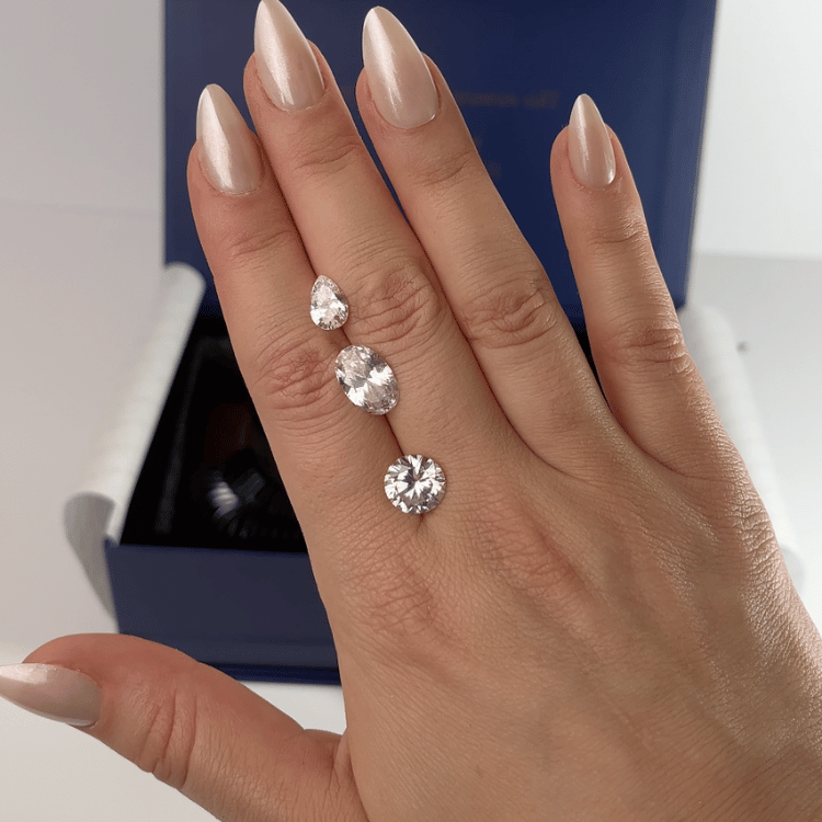 Multiple engagement stone sizes compared on the hand for visual reference