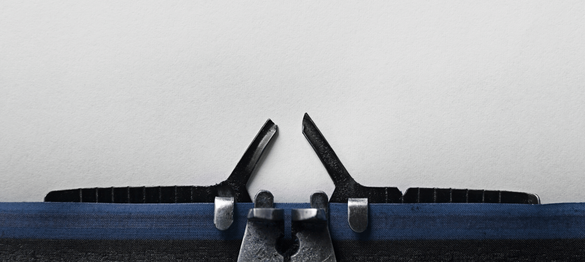 Close-up of a typewriter ribbon and platen on a white background