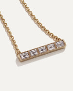 Five-Stone Emerald Diamond Bar Necklace close up, five emerald-cut diamonds set edge to edge in 14k yellow gold