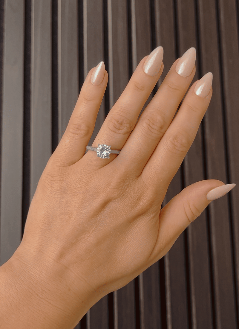 3D printed round engagement ring model worn on a hand for scale