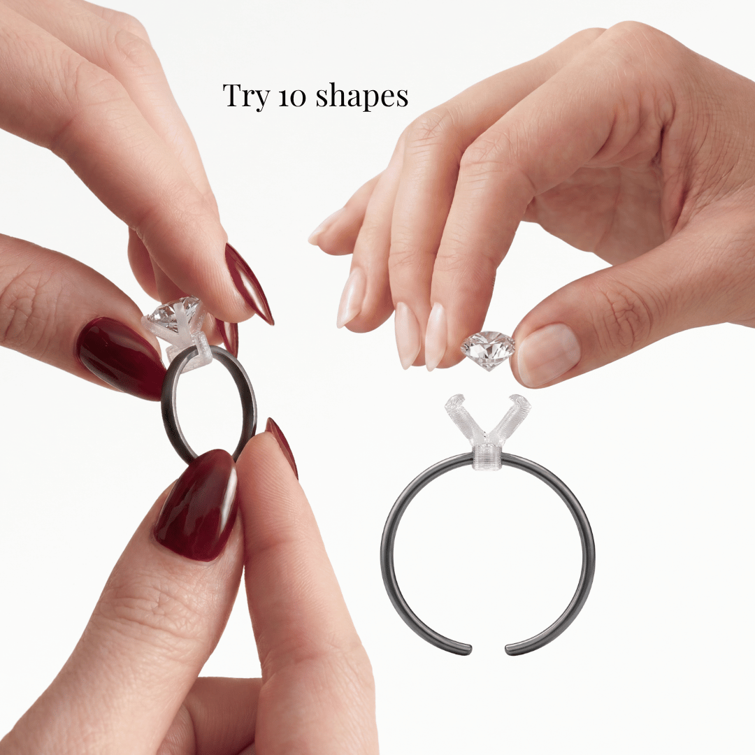 Close-up of ring try-on kit with interchangeable stone in clear prong on open black ring band, white, 'Try 10 shapes'