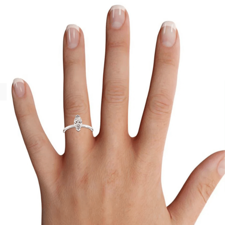 Virtual try-on image showing a marquise-cut engagement stone on the hand