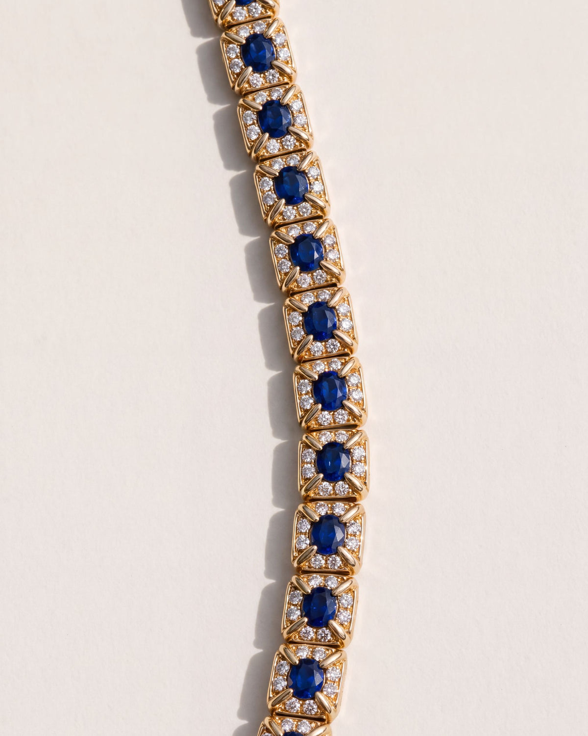 Close up of the Oval Sapphire Halo Bracelet, showing the oval sapphires running lengthways in diamond halo links