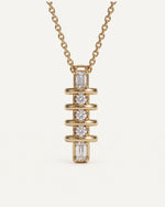 Emerald and Round Diamond Drop Pendant on a 14k gold cable chain, two emerald-cut diamonds and three round diamonds between polished gold bars