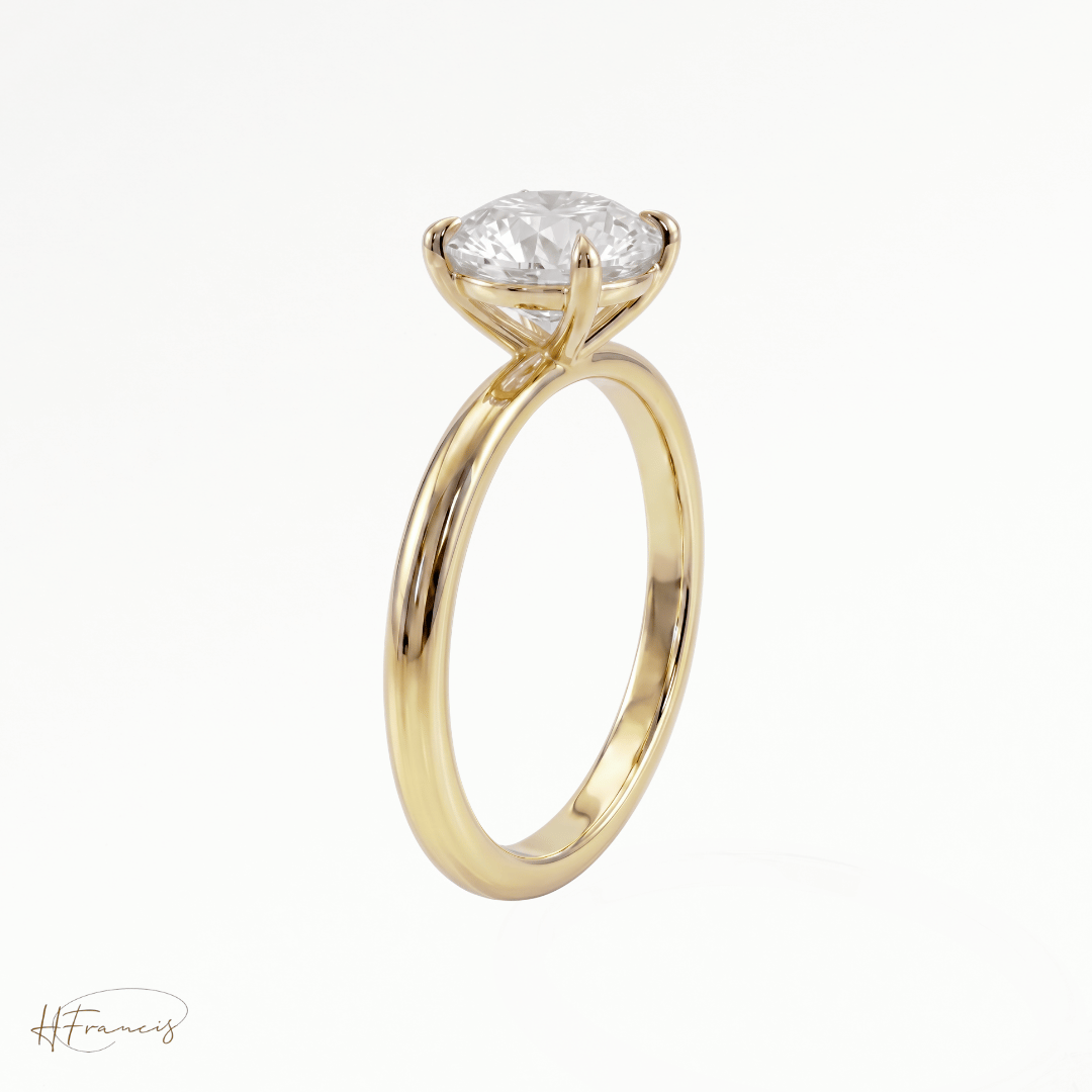 Round classic solitaire engagement ring in 18k yellow gold side view 