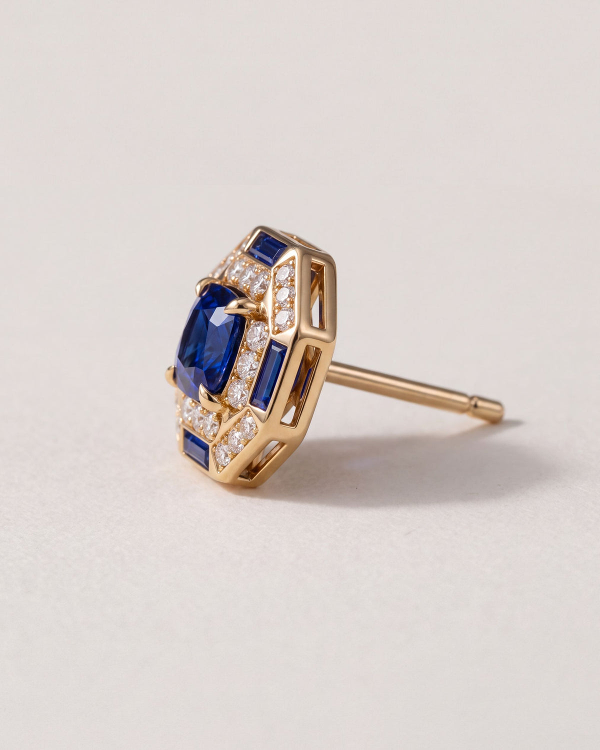Octagon Sapphire Halo Stud from the side, showing the gold post and the open gallery behind the sapphire