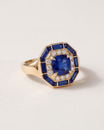 Octagon Sapphire Signet Ring at an angle, showing the wide gold shoulders and the sapphire baguette frame