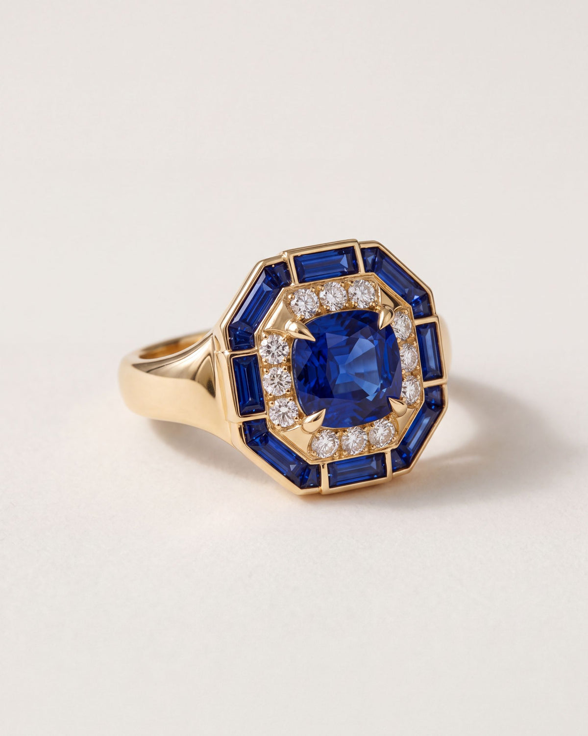 Octagon Sapphire Signet Ring at an angle, showing the wide gold shoulders and the sapphire baguette frame