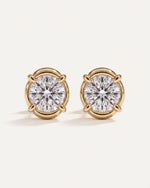Signature Curved Diamond Studs, a pair of 1 carat round diamonds in four claws with a curved 14k yellow gold surround