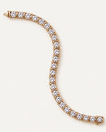Dual Rail Diamond Tennis Bracelet laid flat in a curve, showing the full line of round diamonds in 14k yellow gold