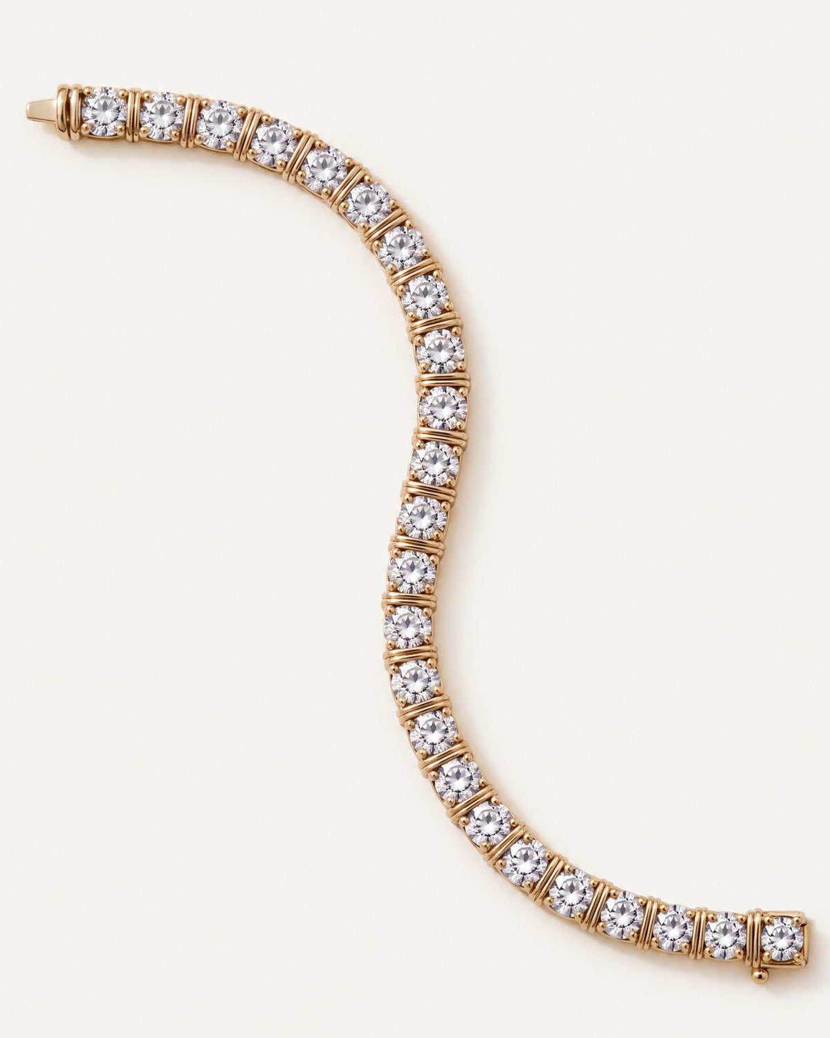 Dual Rail Diamond Tennis Bracelet laid flat in a curve, showing the full line of round diamonds in 14k yellow gold