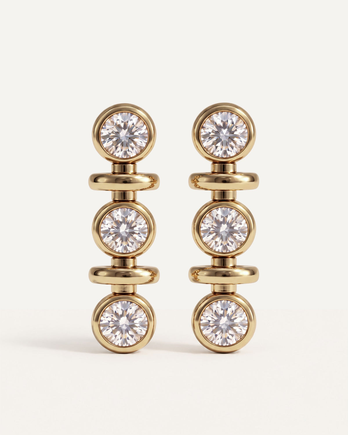 Tri-Diamond Drop Earrings in 14k yellow gold, three round diamonds in each earring, each in its own gold bezel