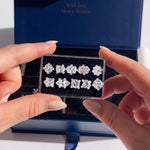 Ten try-on stone shapes in their case, held up in front of the open kit